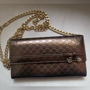 AUTH Gucci Embossed Brown Clutch with Gold Accents